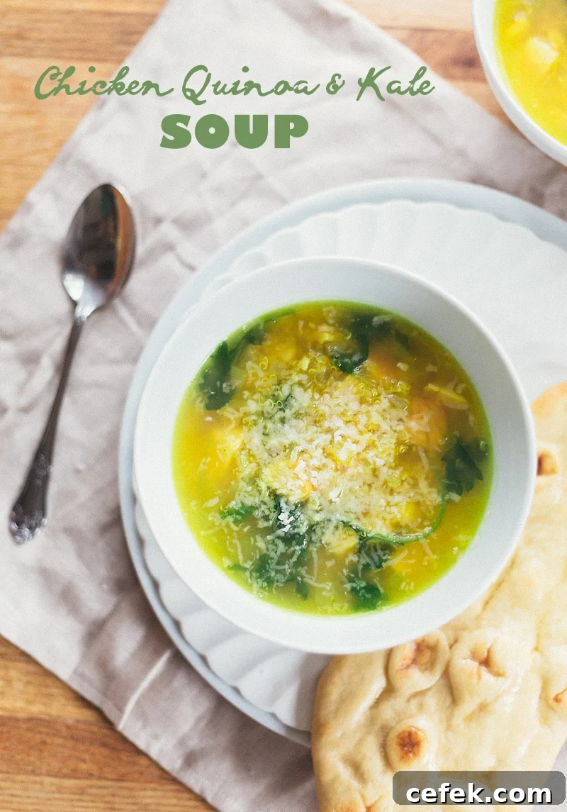 Chicken Quinoa Kale Soup in a bowl topped with parmesan cheese
