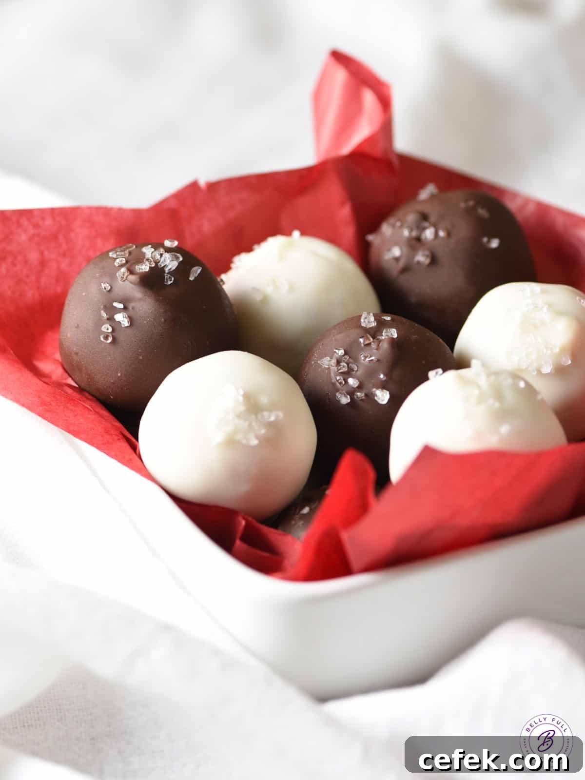 bowl of white and dark chocolate truffles in red tissue paper