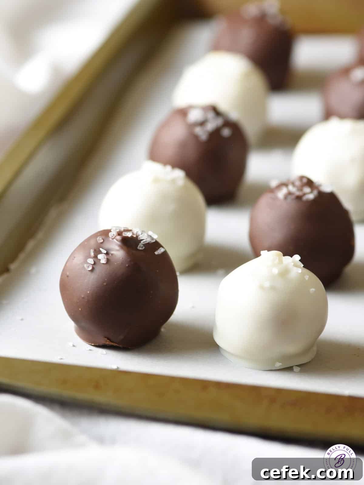 white and dark chocolate coated truffles on baking sheet
