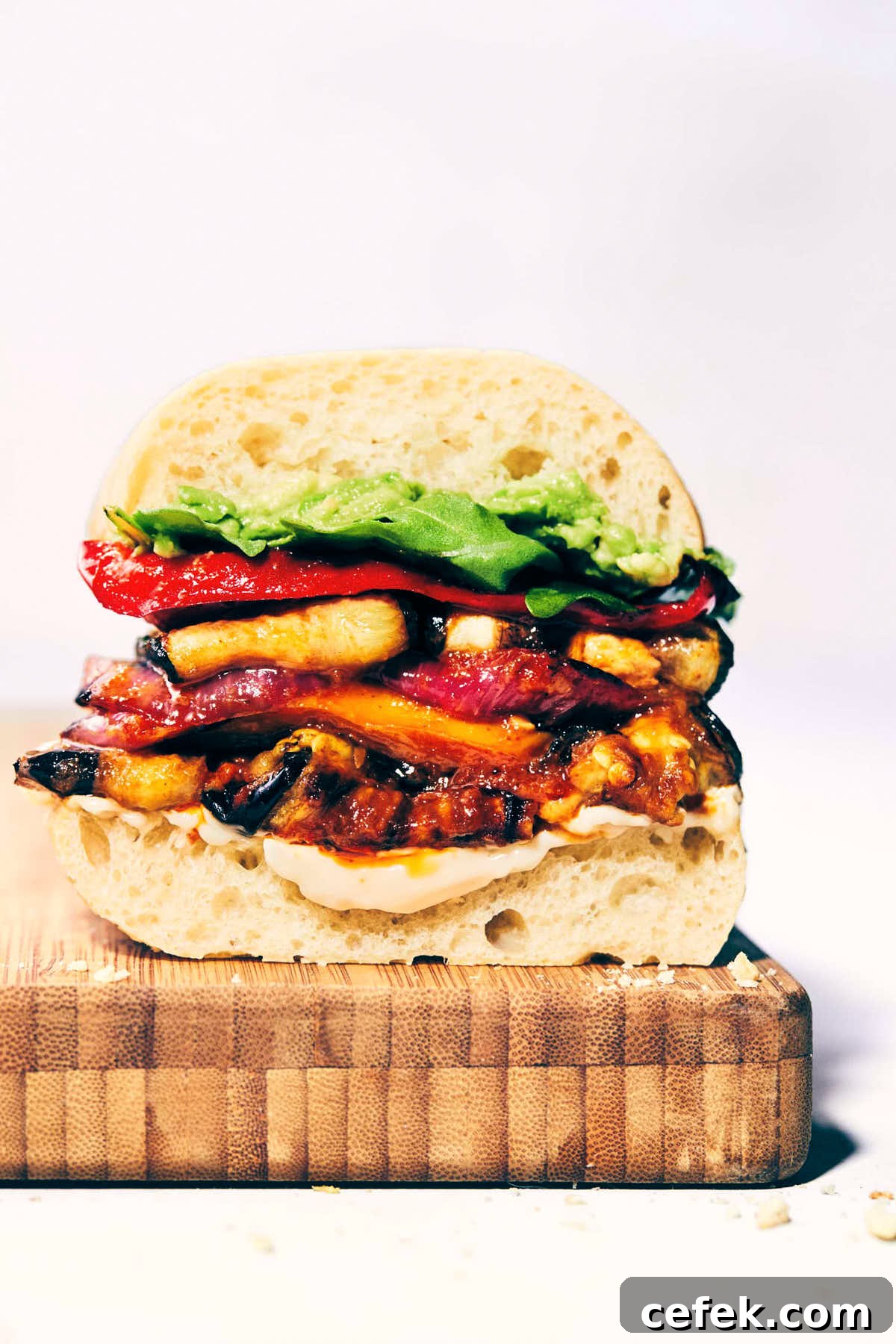 Roasted veggie sandwich with avocado and chipotle mayo on a serving platter