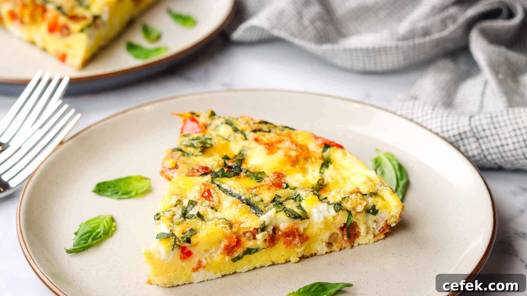 closeup of a slice of goat cheese frittata on a plate