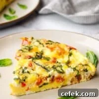 closeup of a slice of goat cheese frittata on a plate