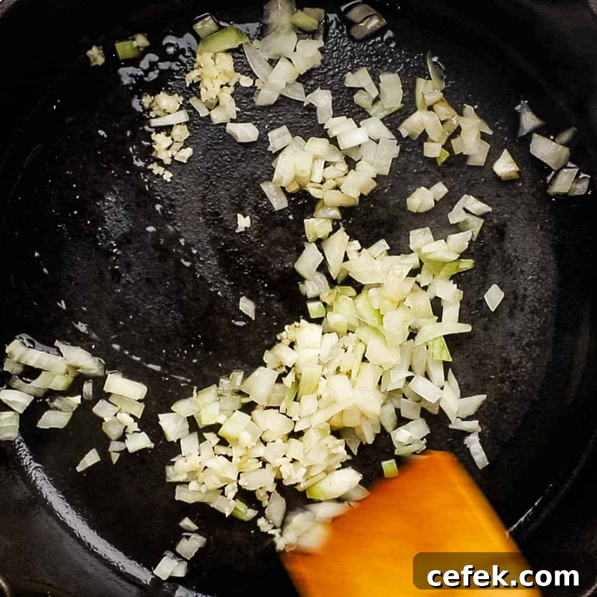 cooking onion and garlic in a cast iron skillet