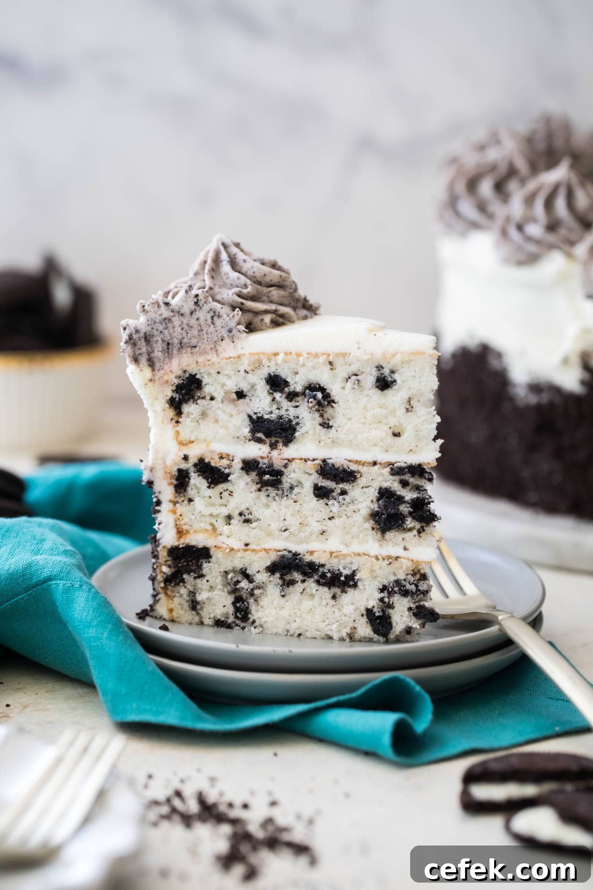 slice of three layer oreo cake on white plate