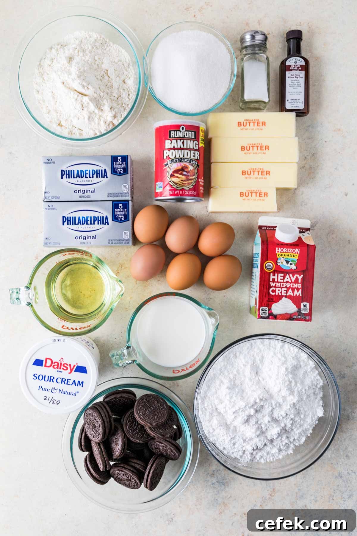 Overhead view of ingredients including flour, eggs, sour cream, oreos, and more.