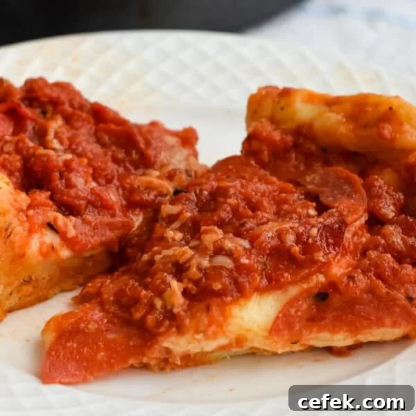 Slices of sourdough deep dish pizza on a plate.