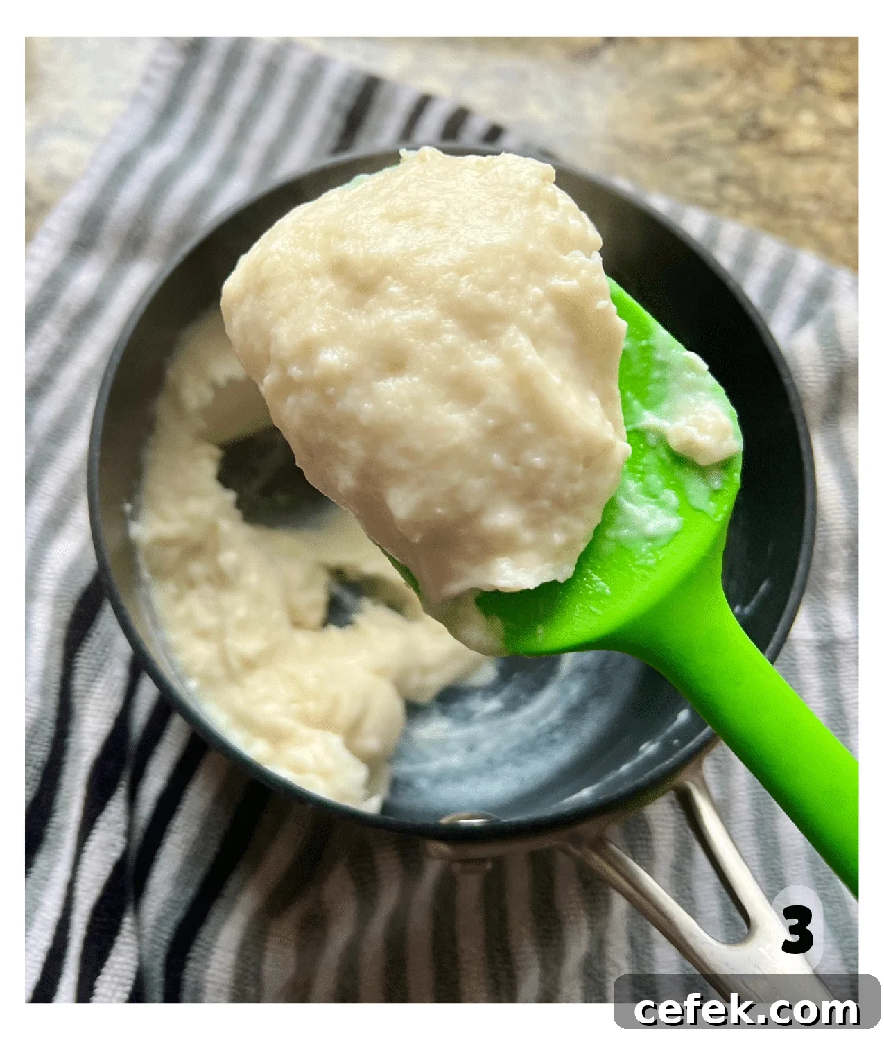 A spoon holds up a scoop of tangzhong, which is a thick pudding-like texture.