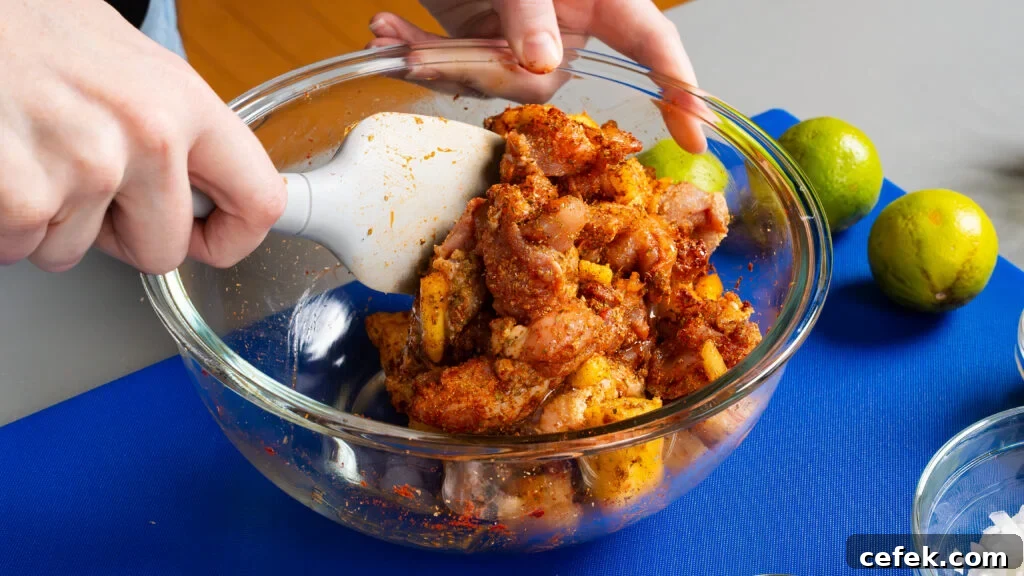 Tossing chicken with spices and pineapple in a bowl