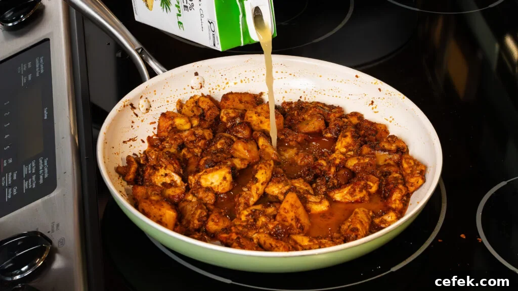 Sauteeing chicken for a delicious chipotle chicken recipe bowl with pineapple and rice.