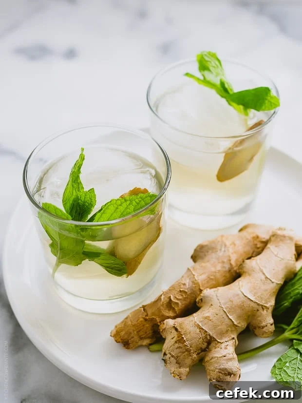 Glasses filled with coconut water coolers alongside fresh ginger.