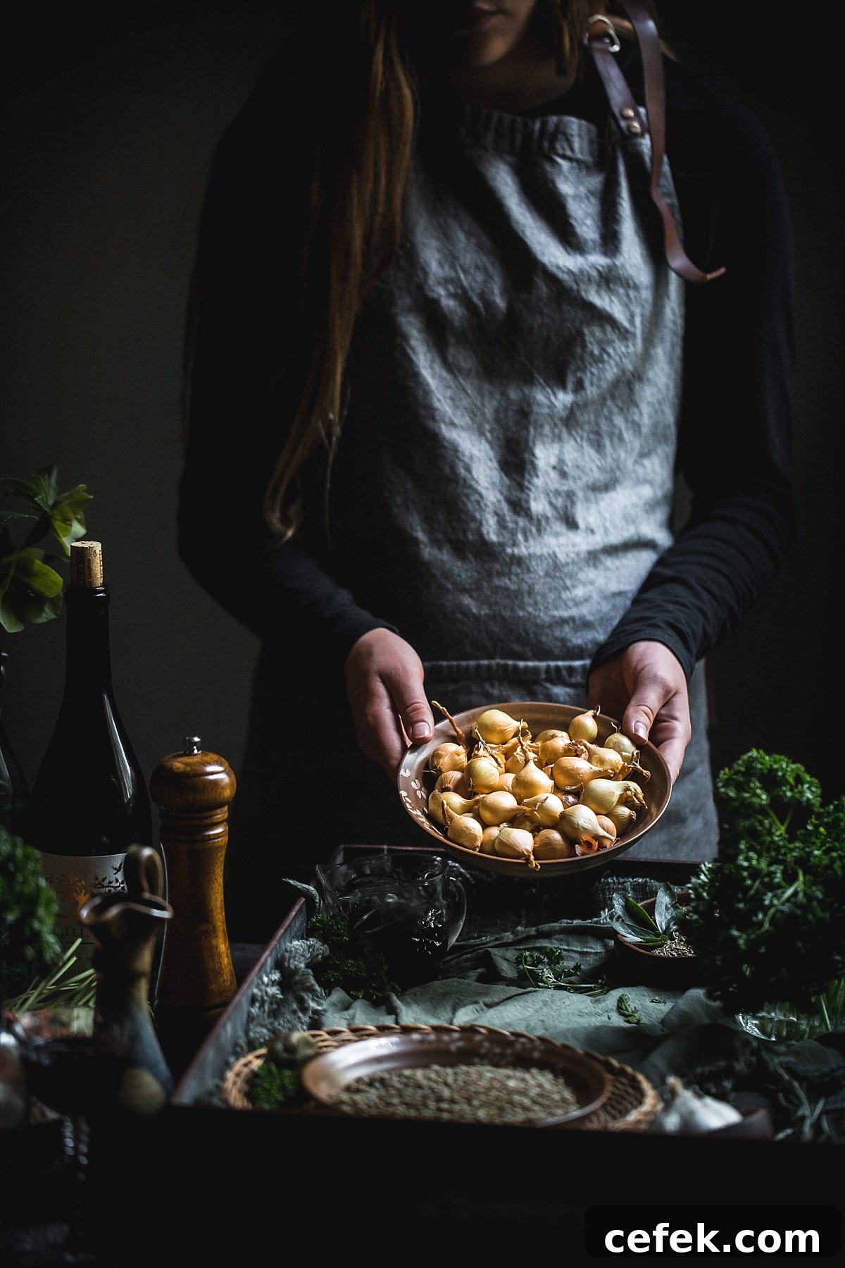 woman holds golden pearl onions for vegan coq au vin
