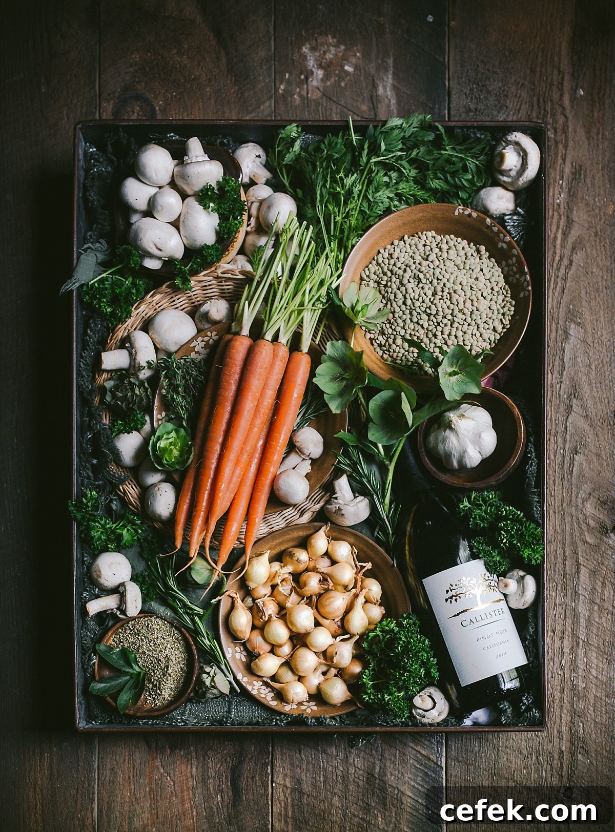 box of ingredients for vegetarian coq au vin including carrots garlic pearl onions and wine