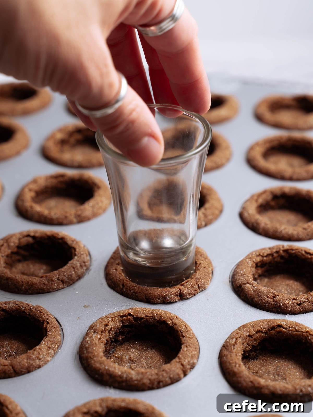 Indenting a freshly baked cookie to create a "cup"
