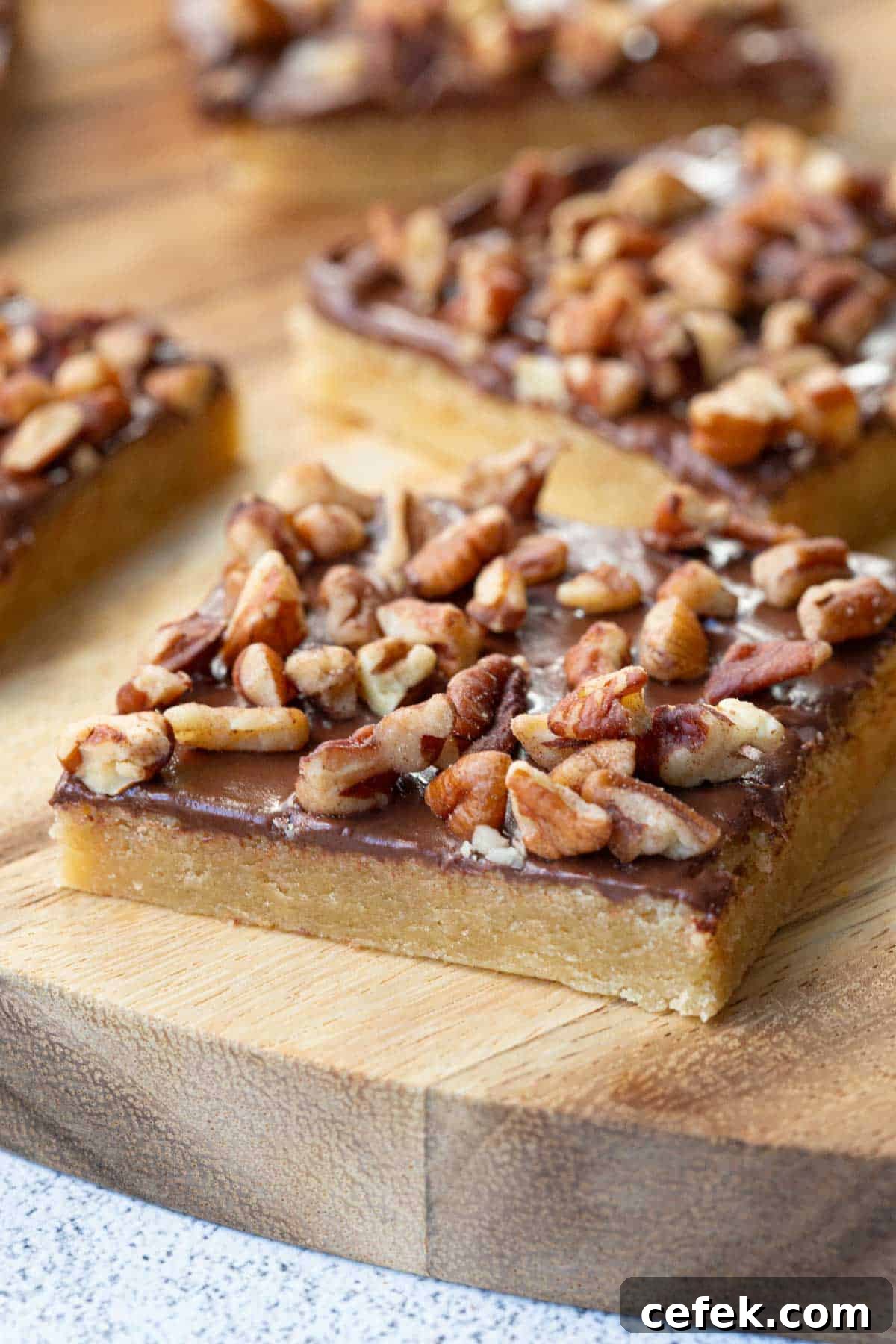 toffee squares on a wooden board.