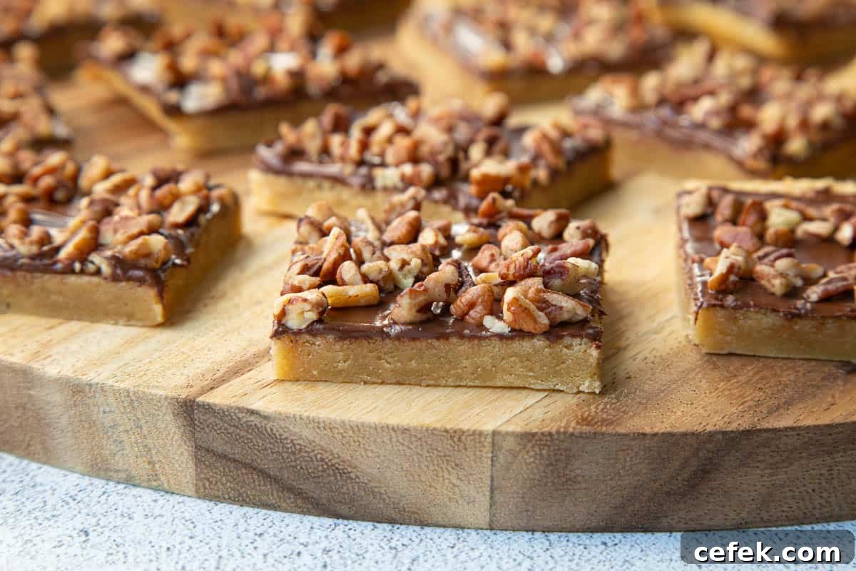 chocolate toffee squares on a wooden board.