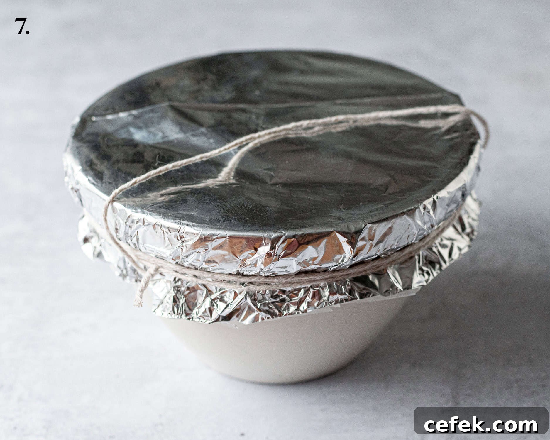 Step 7, the prepared pudding basin tied with string.