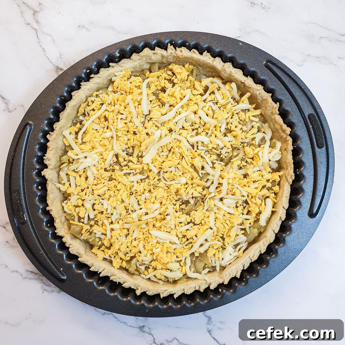 Caramelised onions and grated cheese in a baked pie crust.