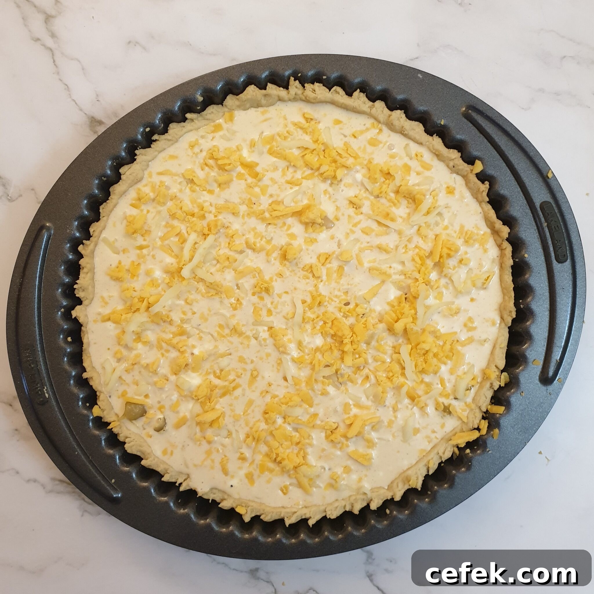 Grated cheese sprinkled on top of the custard.