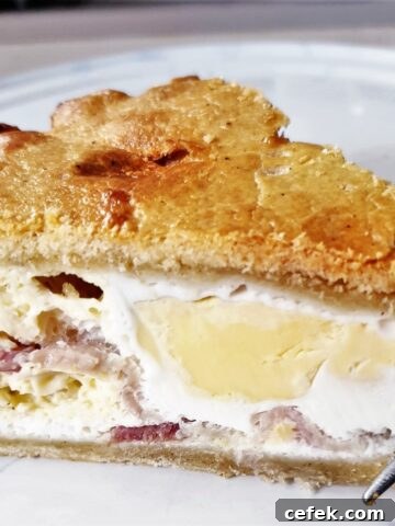 A slice of bacon and egg pie on a plate