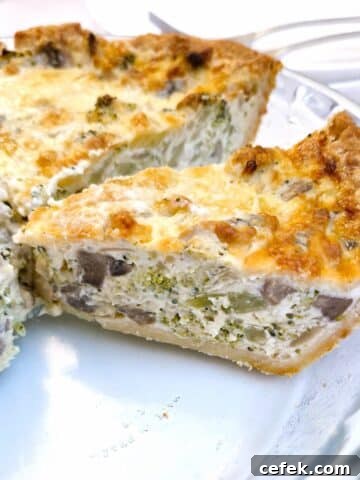 Side-on slices of cheese and broccoli quiche on a glass serving dish.