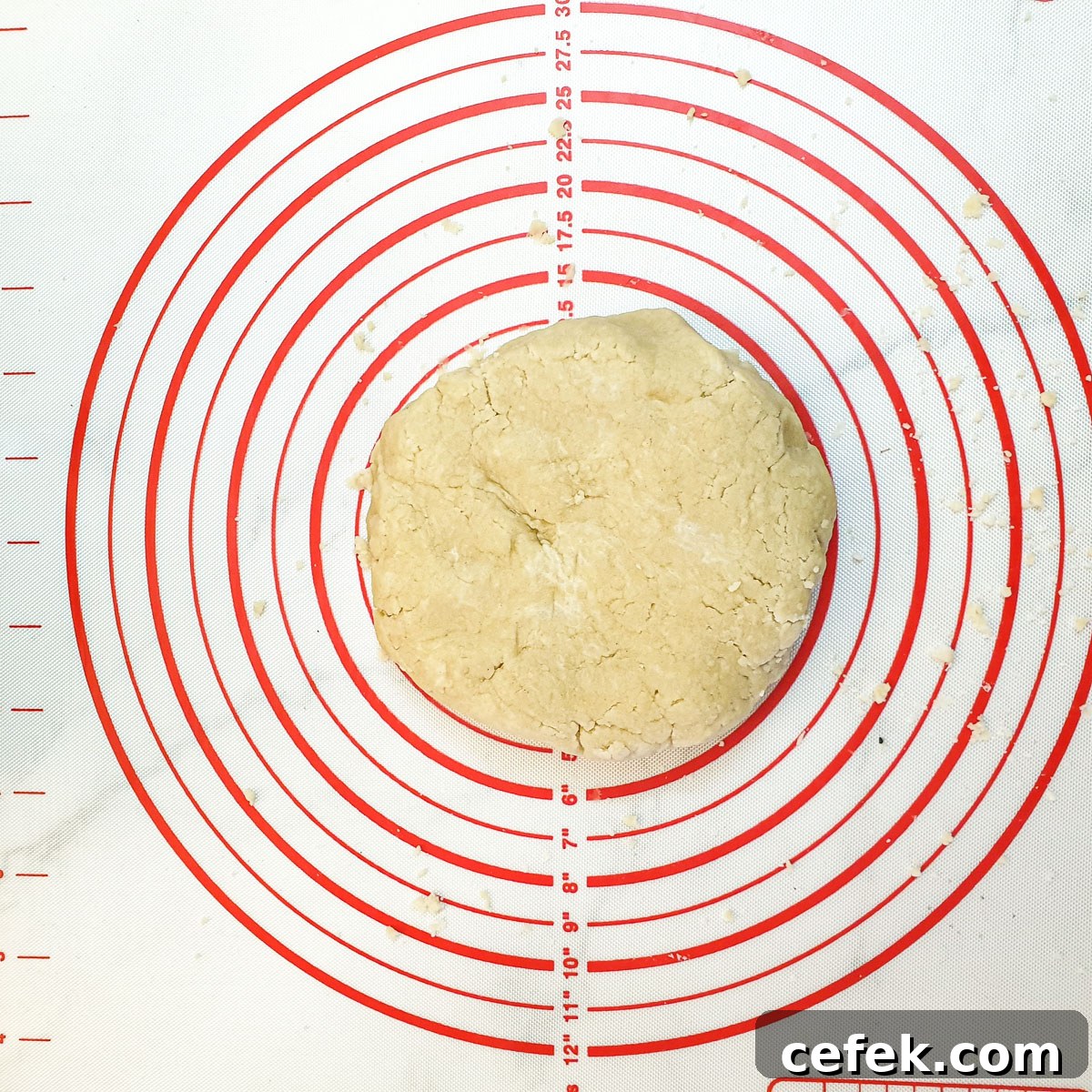 A ball of dough on a rolling mat.