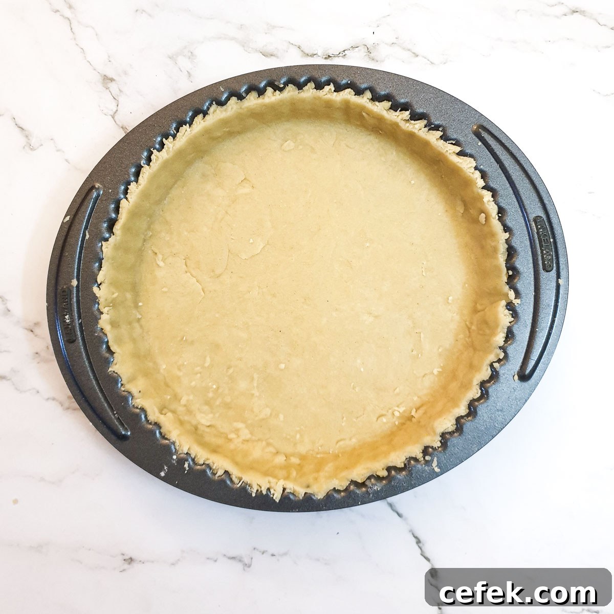 A pie dish lined with pastry.