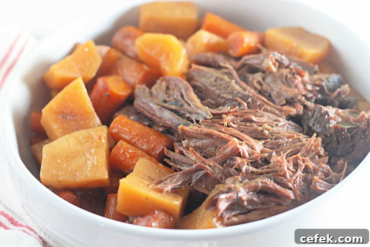 Roast beef, potatoes, and carrots in a bowl.