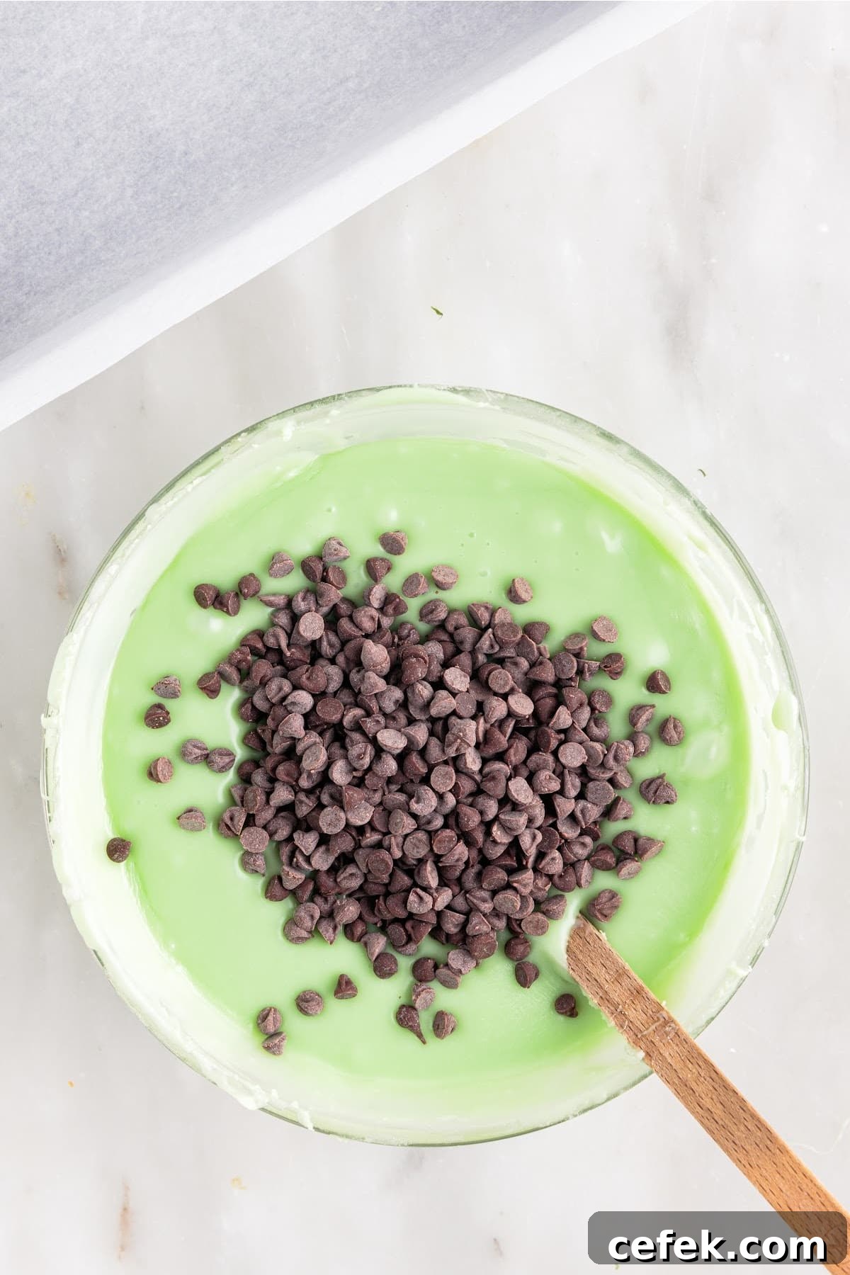 Stirring in the mini chocolate chips.