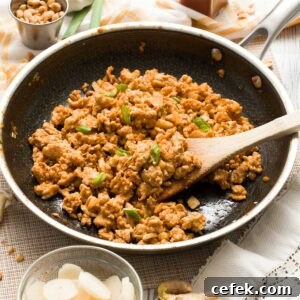 Asian ground chicken filling in a HexClad hybrid pan with a wooden spatula.