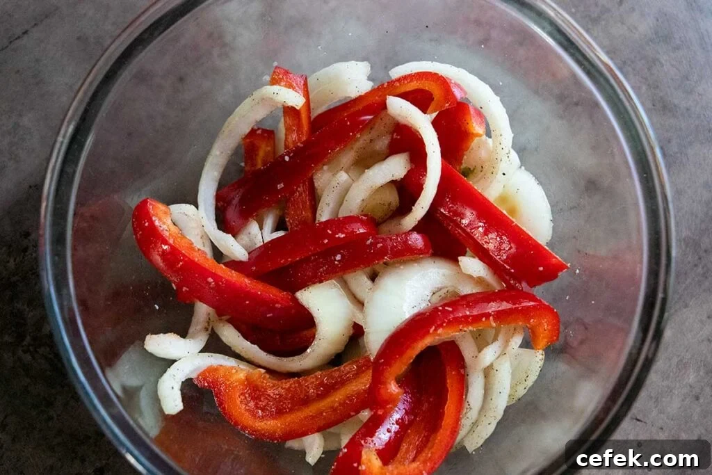 Onions and red peppers cut in a glass bowl