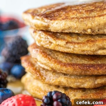 stacked pancakes with oat flour on plate and fruit