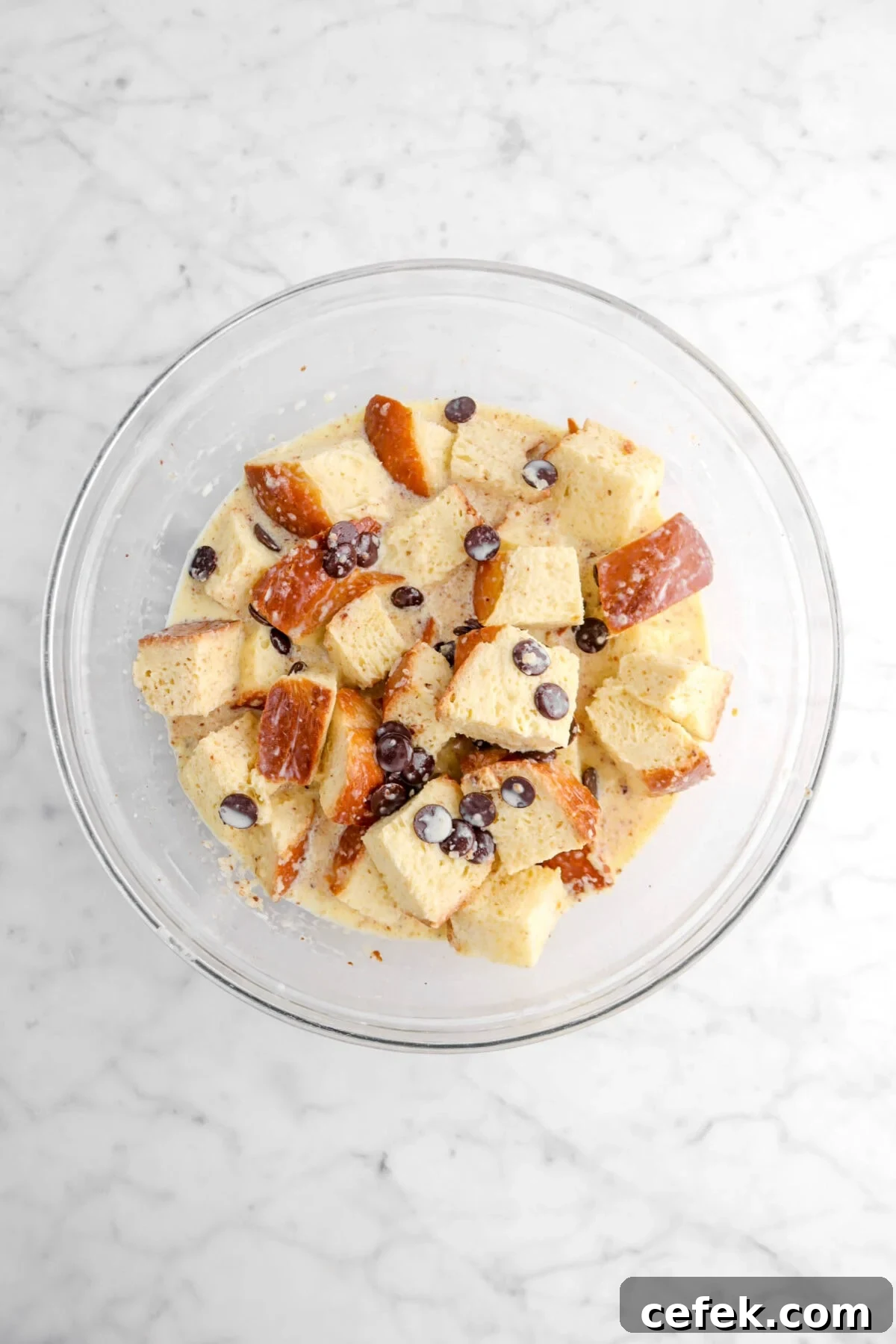 bread pudding mixture in glass bowl.