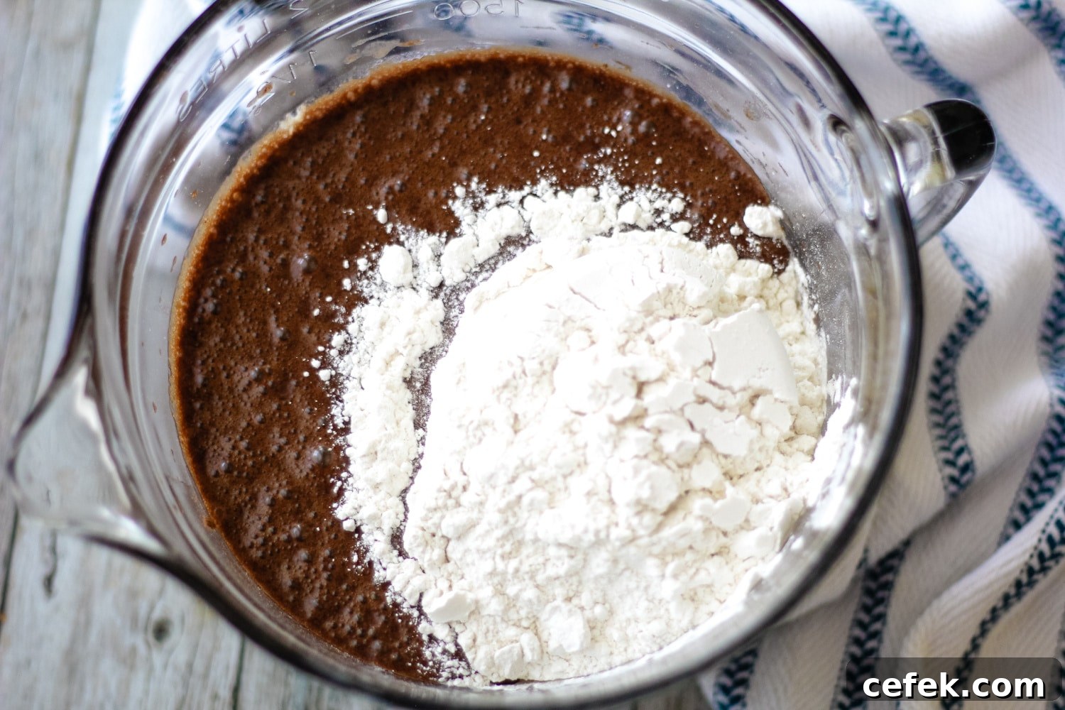 ingredient for mississippi mud cake frosting in a bowl