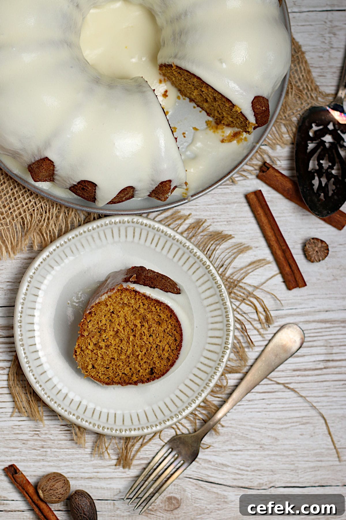 An overhead photo of a slice of Pumpkin Spice Bundt Cake with glaze on a white plate.