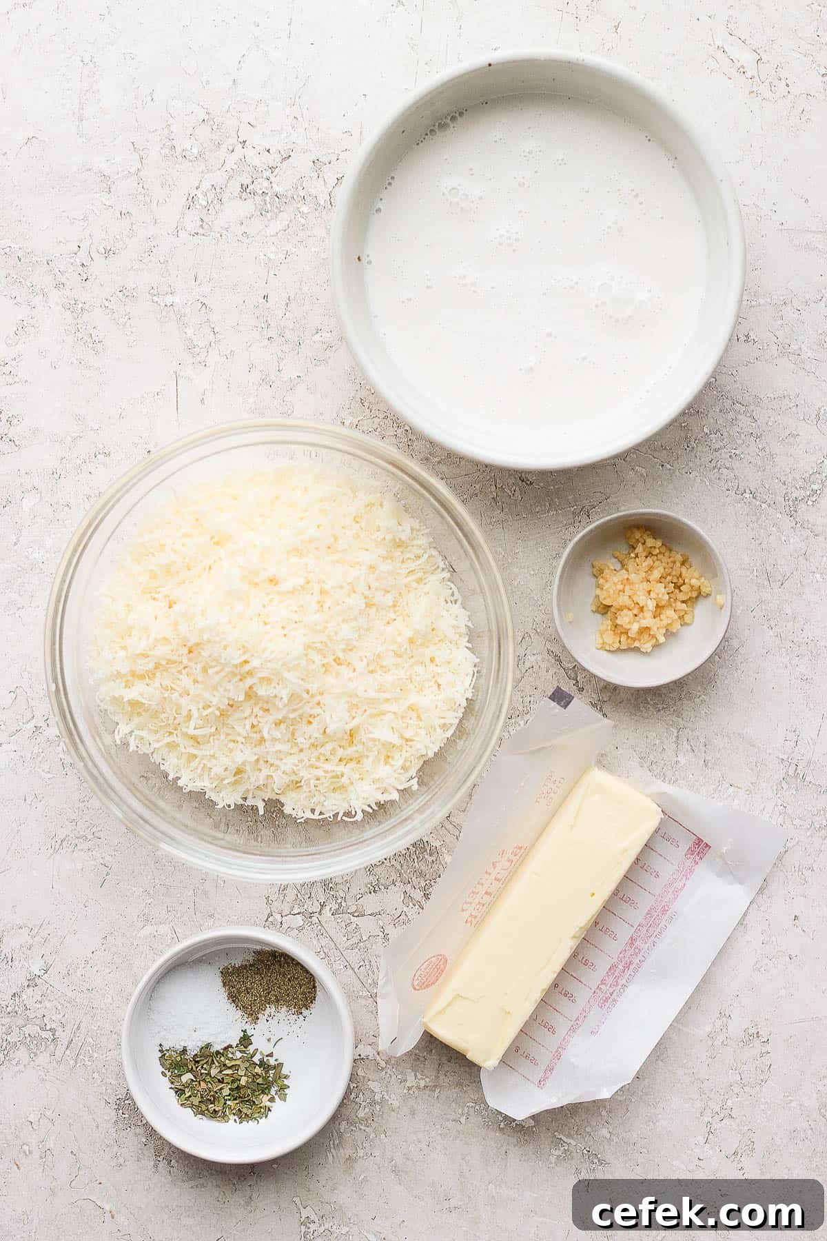 Ingredients for alfredo sauce in a separate bowls.