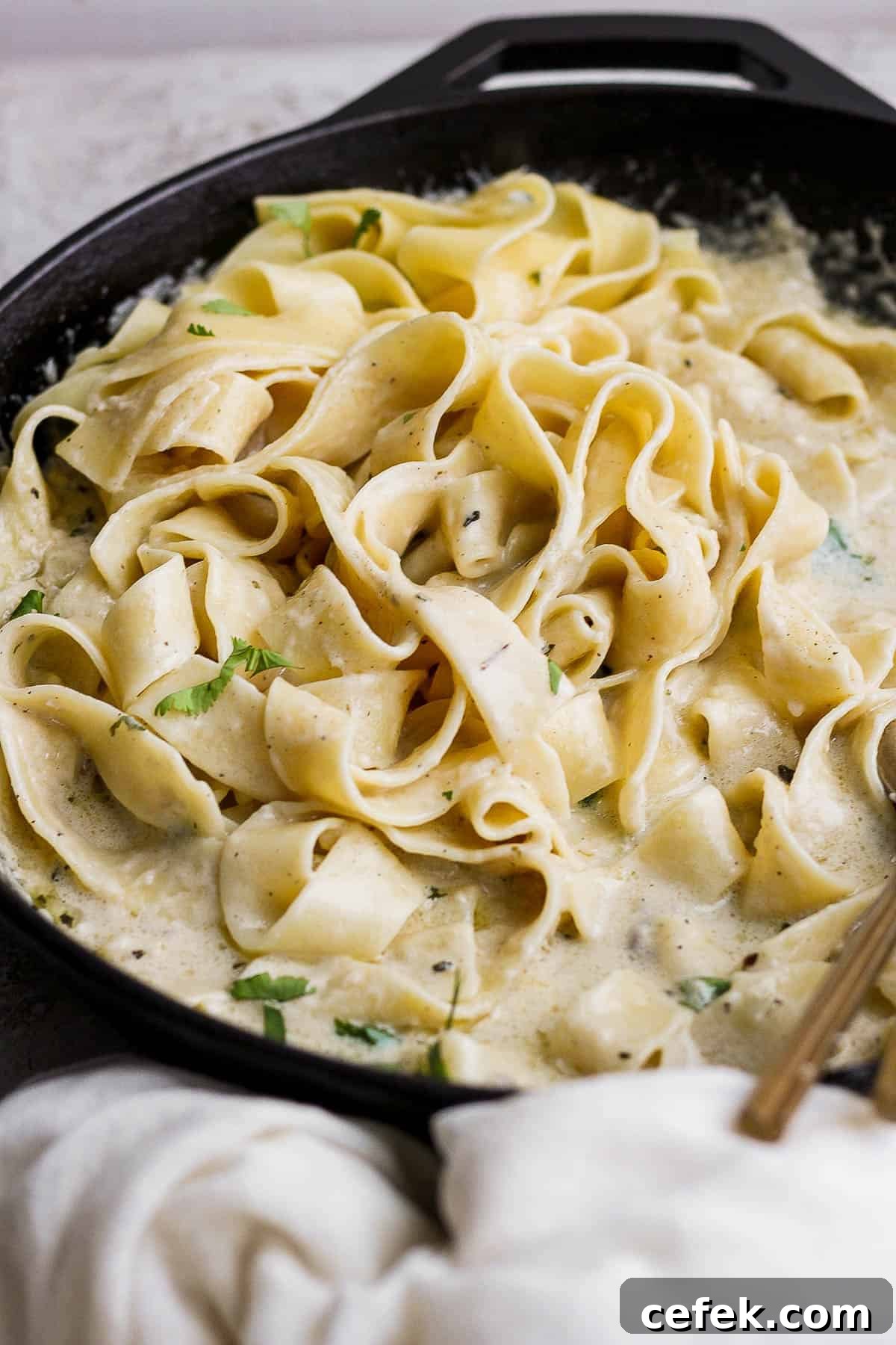 A homemade alfredo pasta in a skillet.