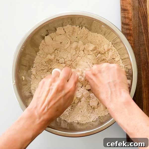 Crumbling the cold butter into the flour mixture.