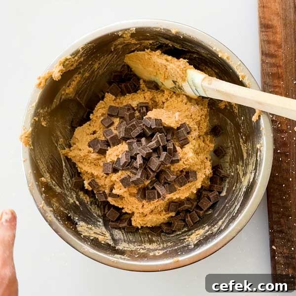 Stirring the chocolate chunks into the scone dough.