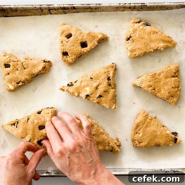 Placing the scone wedges on a cookie sheet lined with parchment paper.