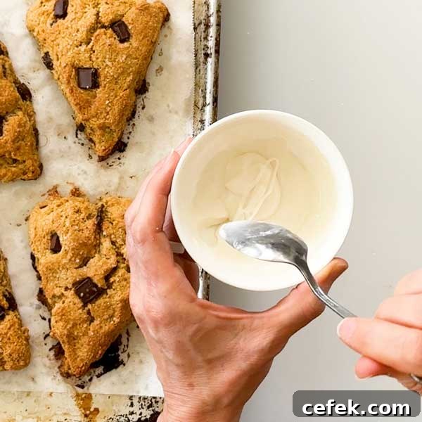 Mixing the powdered sugar and milk together in a bowl.
