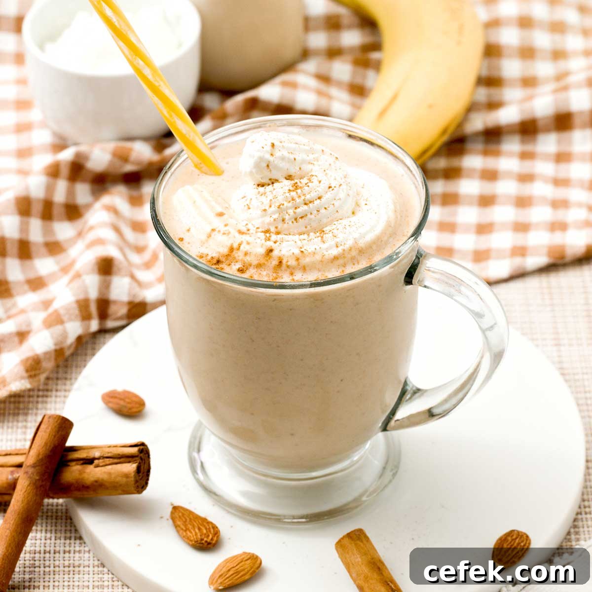 A cinnamon roll protein smoothie with greek yogurt and whipped cream on top.