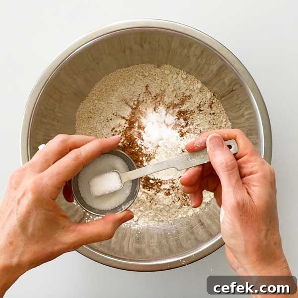 Adding the dry ingredients to a bowl.