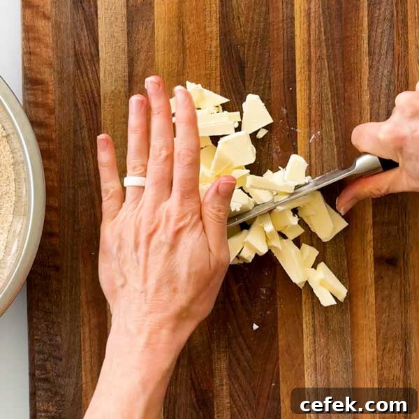 Dicing the cold butter on a cutting board.