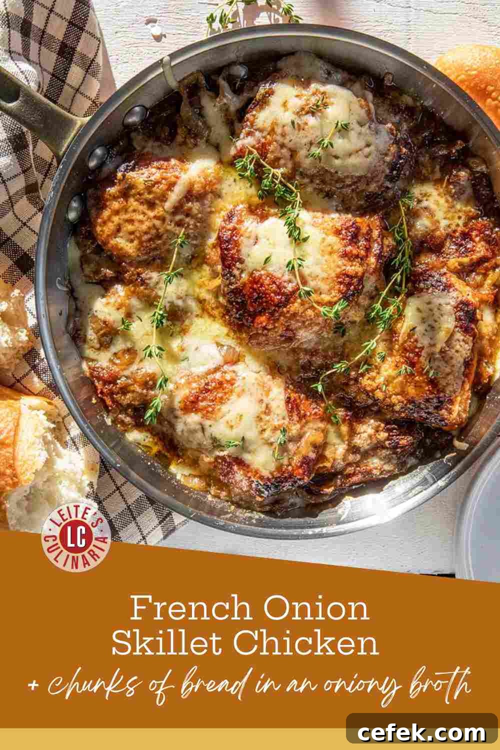 Golden seared chicken thighs in a skillet with caramelized onions, melted cheese, and fresh thyme sprigs.