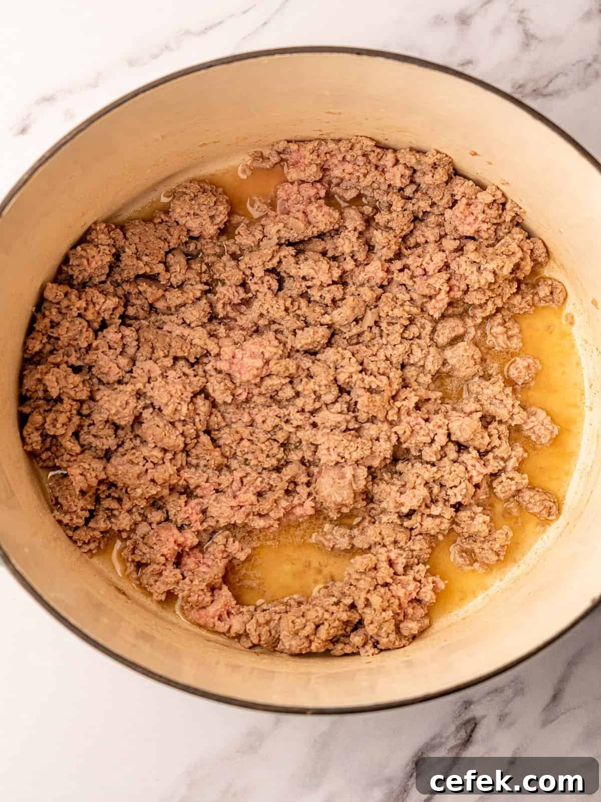 Ground turkey browned and crumbled in a pot.