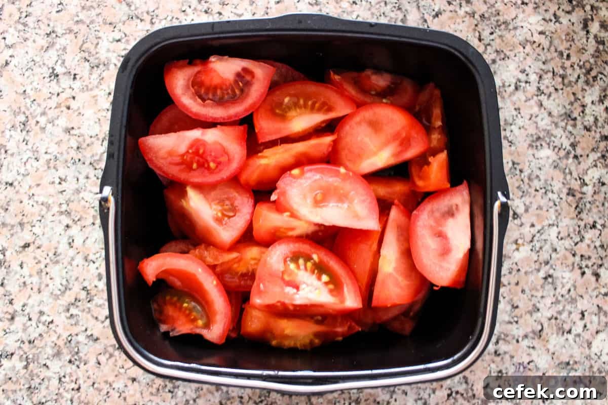 Tomatoes cut up and in baking dish.