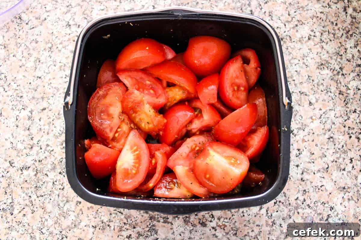 Seasoned tomatoes in a square baking dish.
