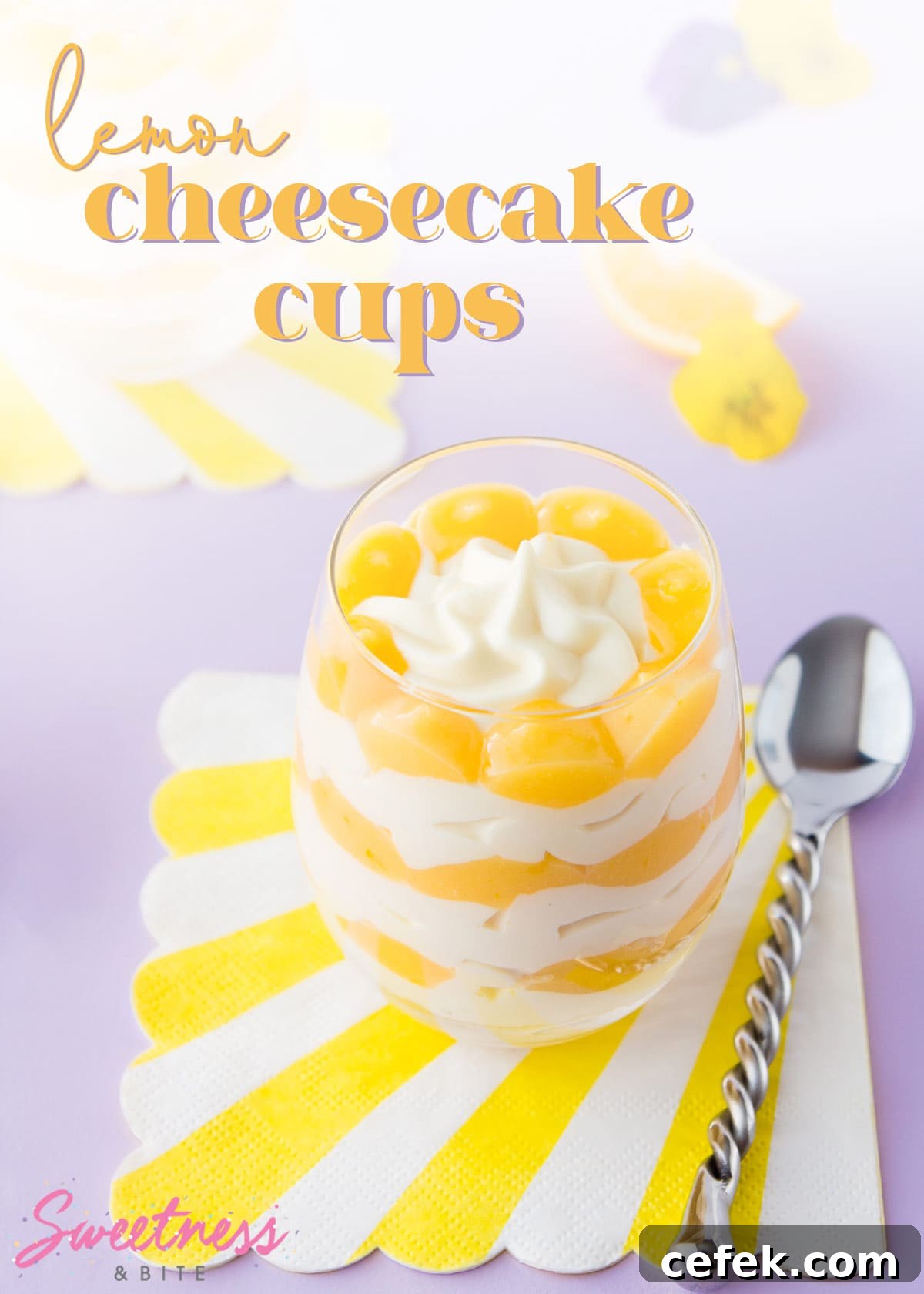 A layered lemon cheesecake in a stemless wine glass, text overlay reads 'lemon cheesecake cups'.