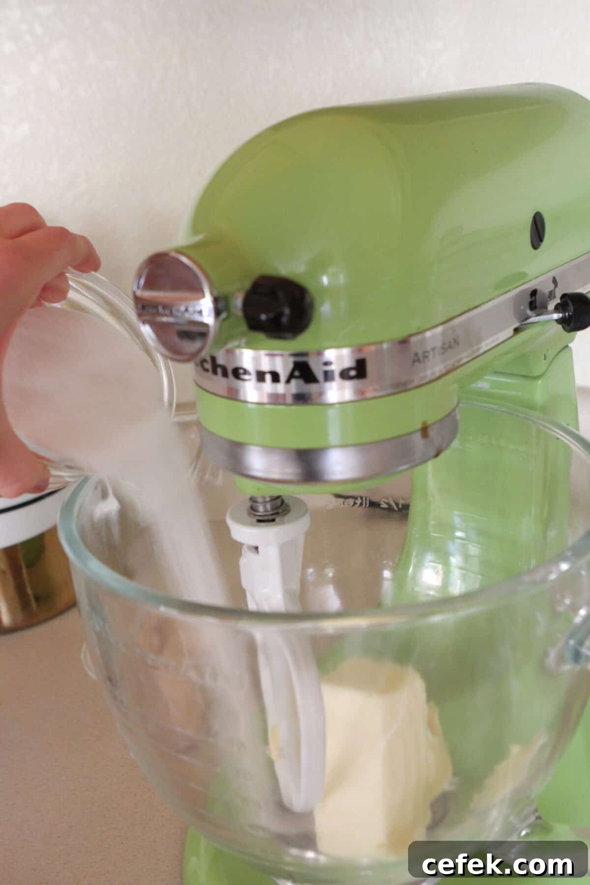 adding sugar to butter in stand mixer