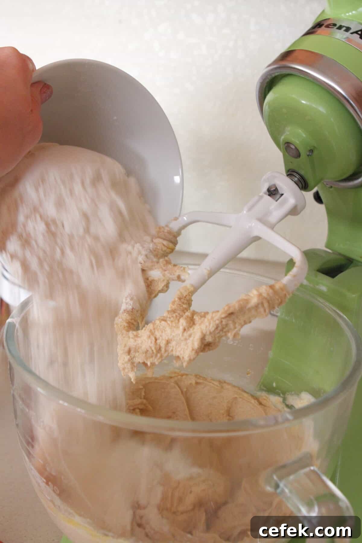 adding flour to stand mixer of cookie dough